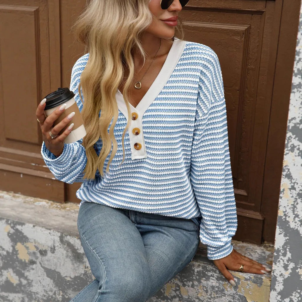 Women's loose-fitting long-sleeved V-neck top with button detail and patchwork design.