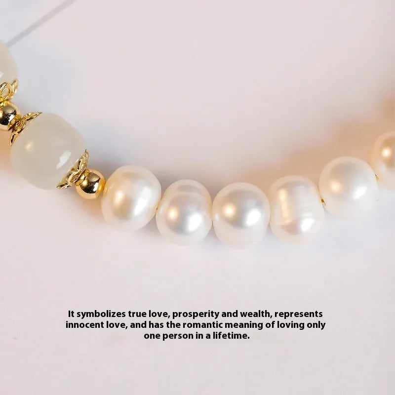 Diamond-shaped freshwater pearl bracelet in electroplated Hetian jade colour on a wrist.