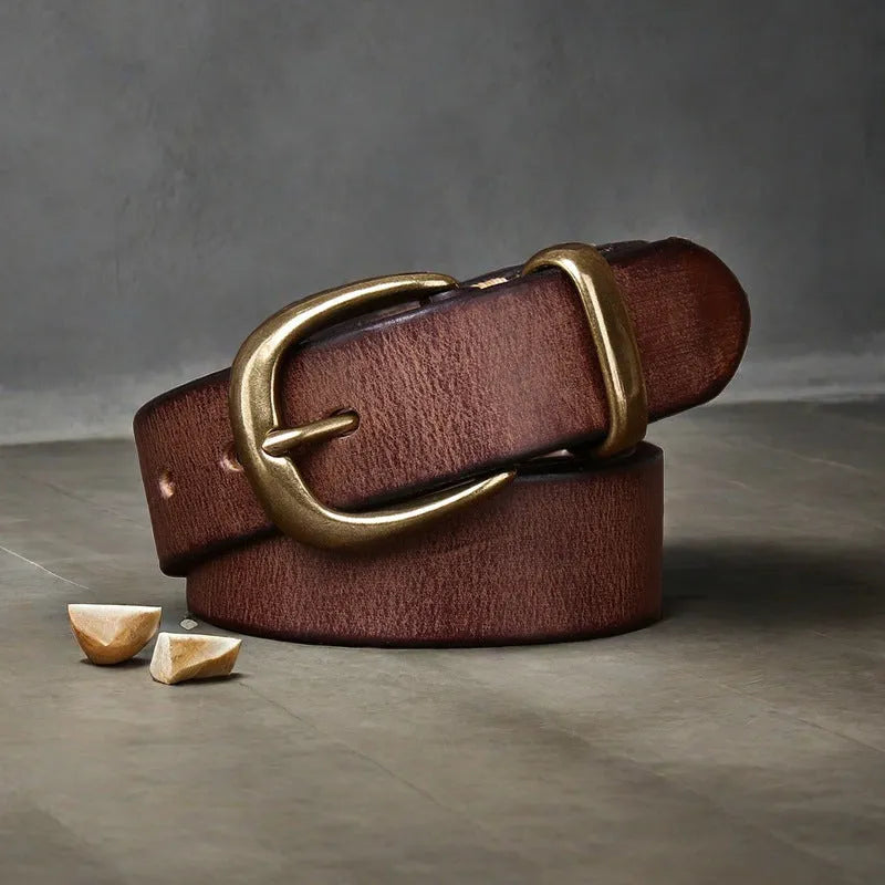 Men's black cattlehide leather belt with a copper pin buckle shown on a flat surface.