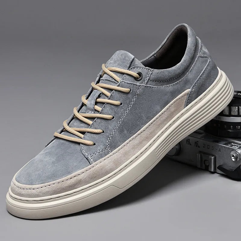 Men's grey pigskin leather casual skate shoes with a flat rubber sole and lace-up front.