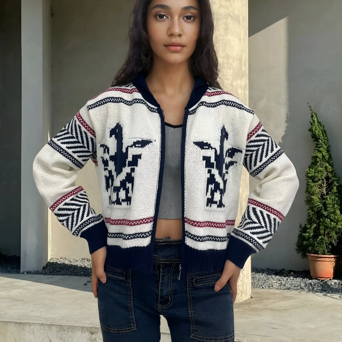 White women's cardigan with jacquard stripe pattern, zip front, and lapel collar on a hanger.