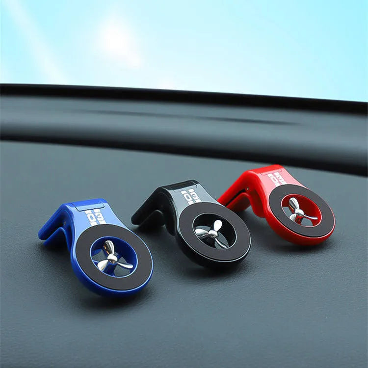 Black magnetic car phone holder with fragrance slice mounted on a car air vent
