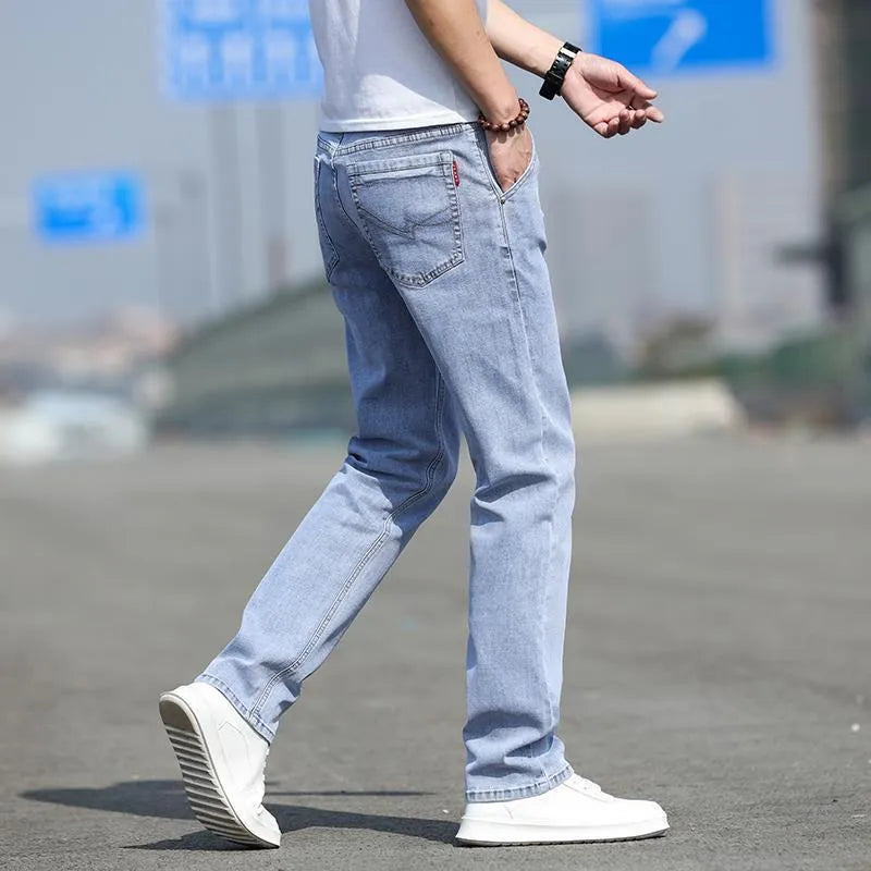 Men's smoky gray straight leg jeans with low waist design and zipper fly closure
