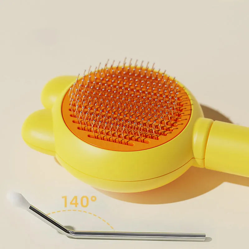 Self-cleaning pet grooming brush with release button showing stainless steel teeth and ergonomic handle