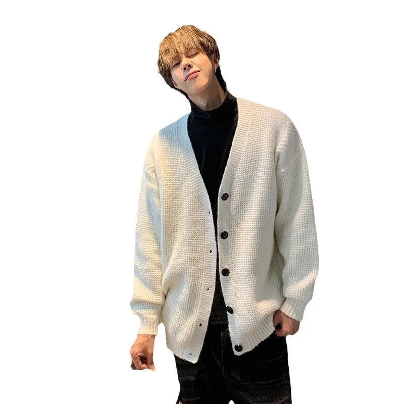 Men's loose fit V-neck cardigan sweater in a solid colour, shown on a casual model.