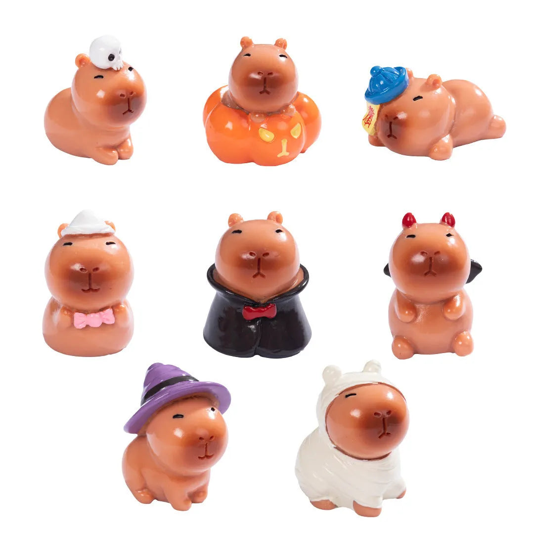 Eight small resin and plastic capybara figurines with different Halloween-themed designs.