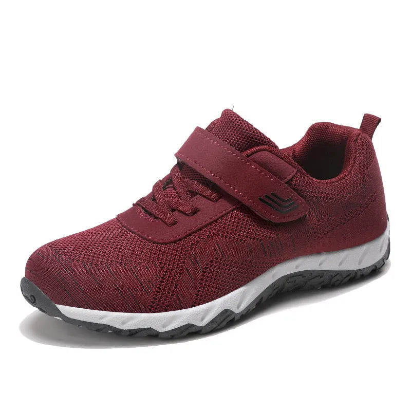 Grey purple women's low-top shoes with a velcro strap and wedge sole on a white background.