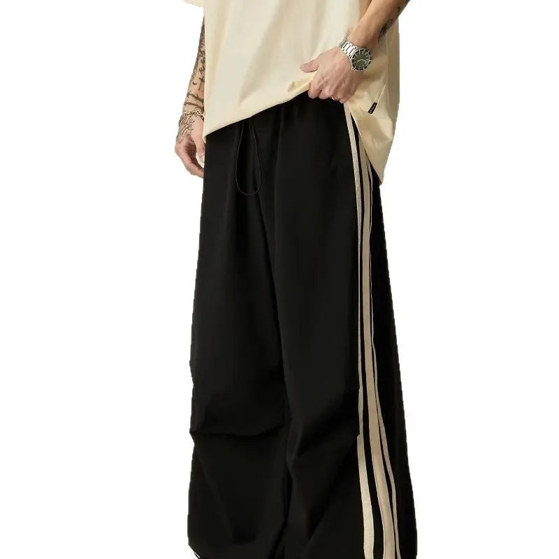Black men's wide leg climbing trousers with a high waist and straight leg on a mannequin.