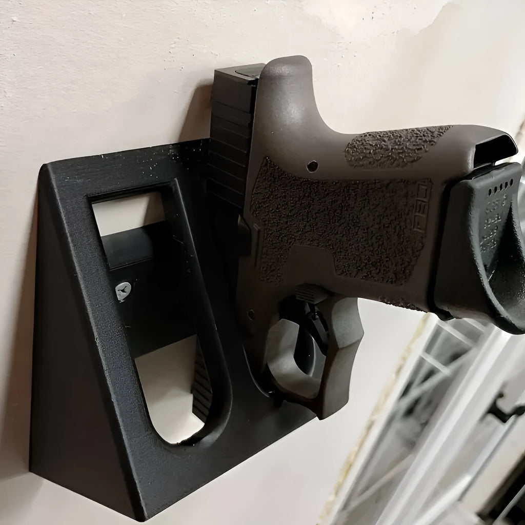 Black punk-style plastic pistol stand for displaying replica guns.