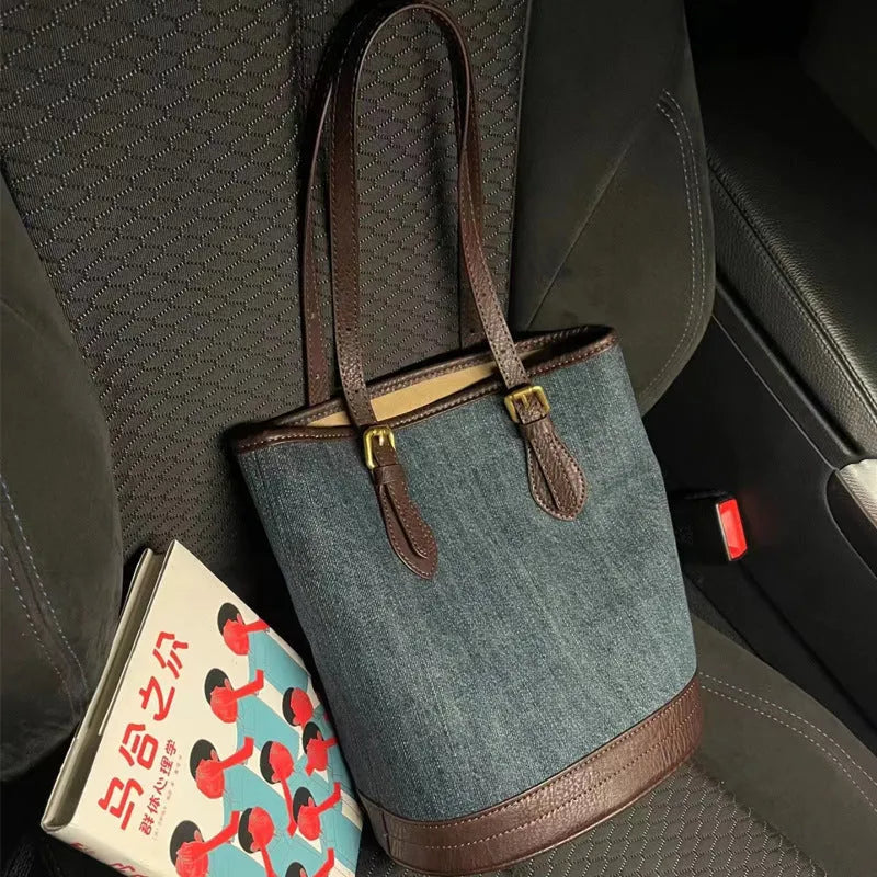 Denim patchwork one-shoulder bucket handbag with large open top, shown in denim commuter colour.