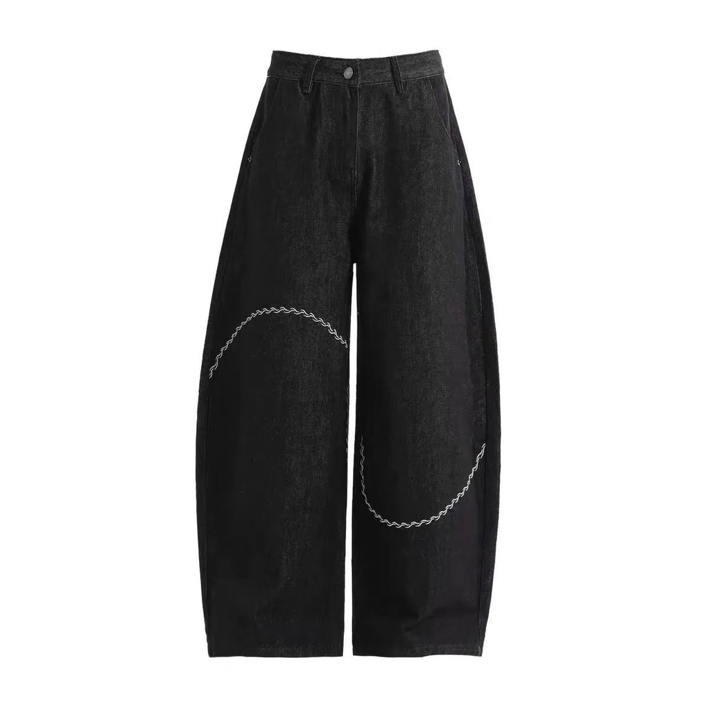 Black straight-leg denim trousers with a mid-waist and zip fly on a plain background.