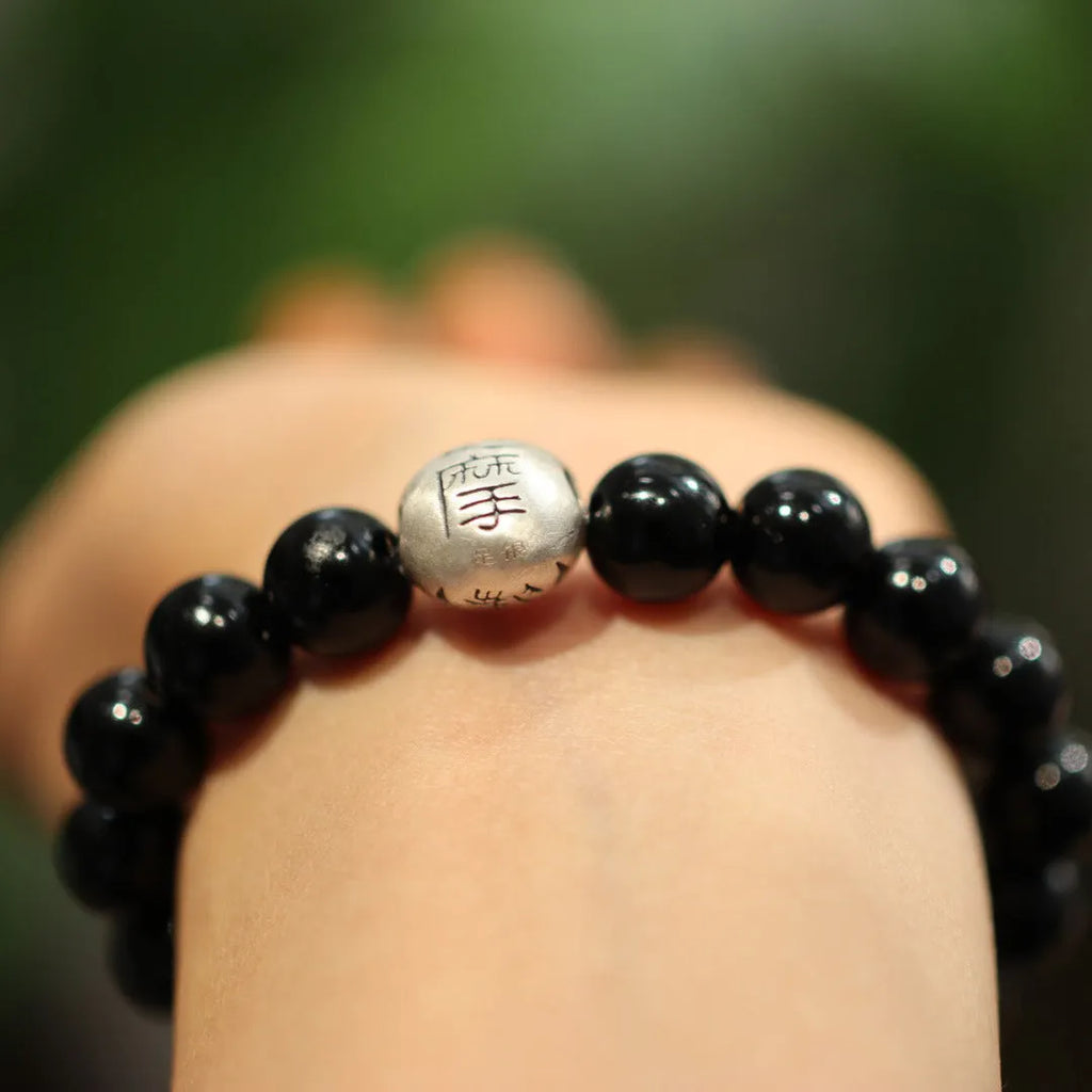 Black agate bead bracelet with sterling silver fastening on wrist