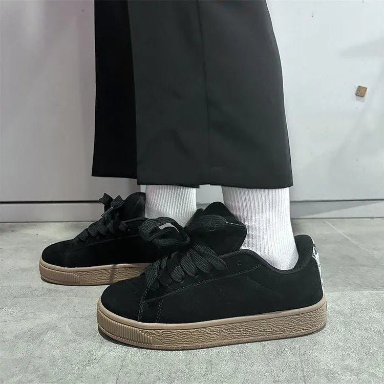 Black retro low-top sneakers with lace-up front, round toe, and waterproof platform sole