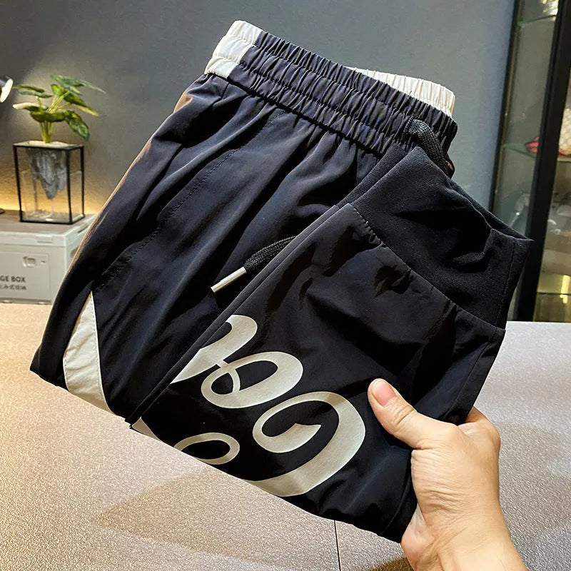 Black men's cropped casual trousers with ankle band, made from ultra-thin ice silk fabric.