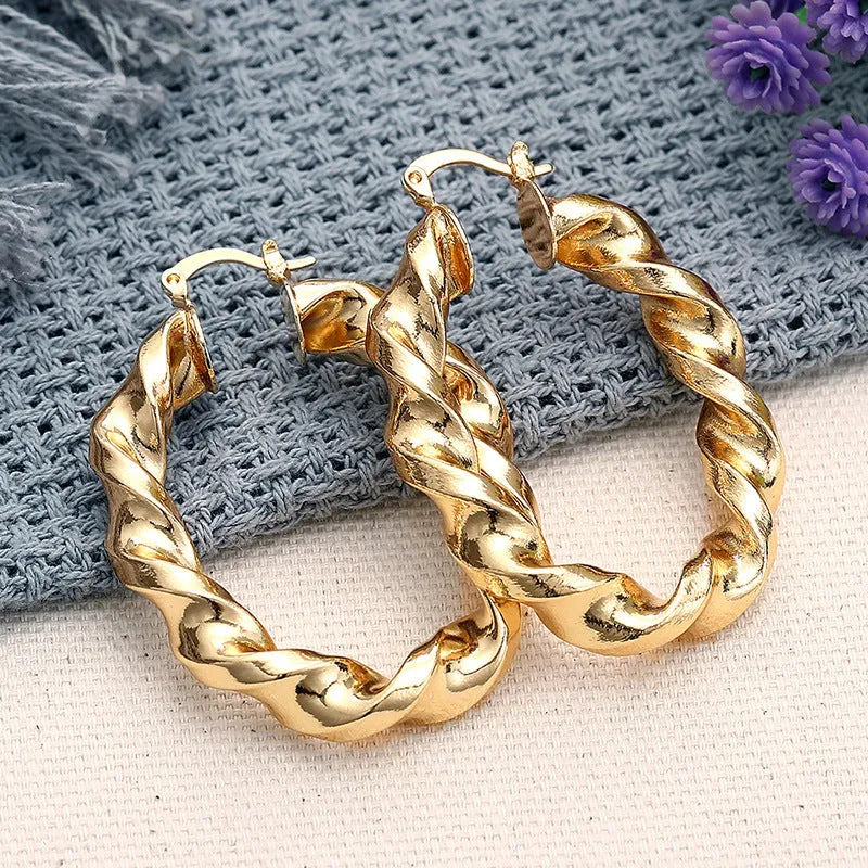 Women's geometric drop-shaped ear clips with ring and line elements in copper electroplated finish