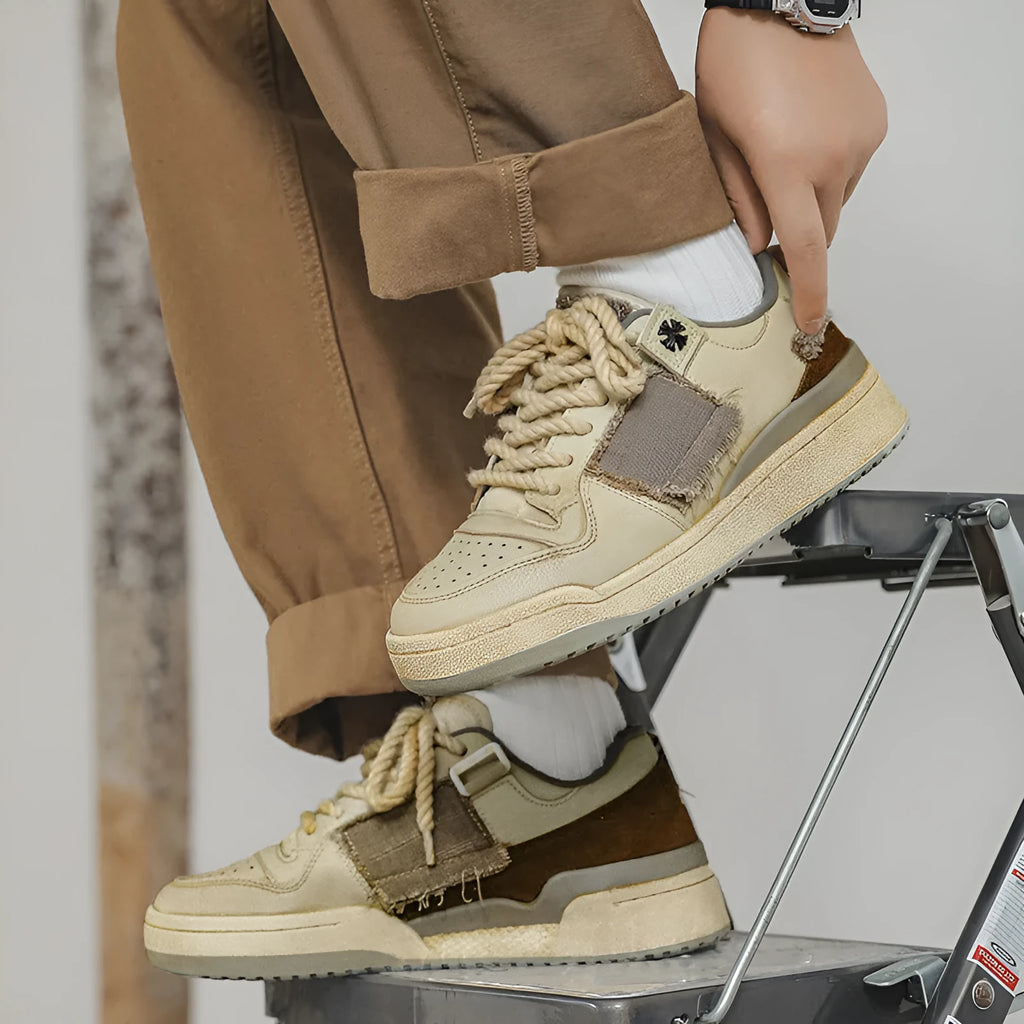 Beige low-top vintage style skateboard shoes with round toe and lace-up front on a rubber sole.