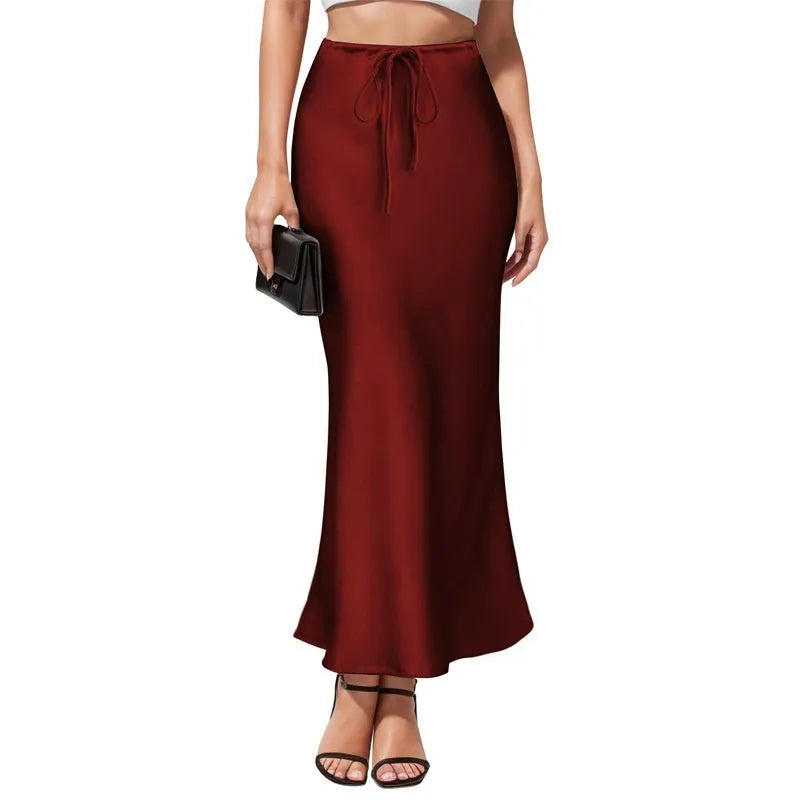 Women's high-waist asymmetric satin skirt in black with irregular stitching detail.