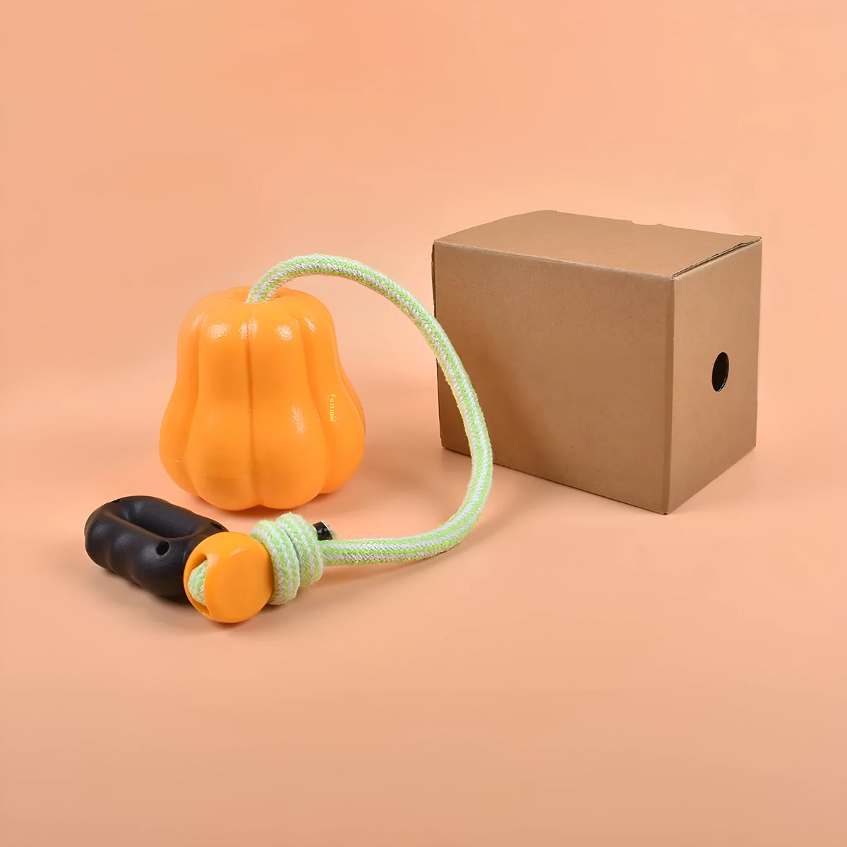 Orange pumpkin-shaped plastic dog toy with bite molar texture and rope handle for aggressive chewers