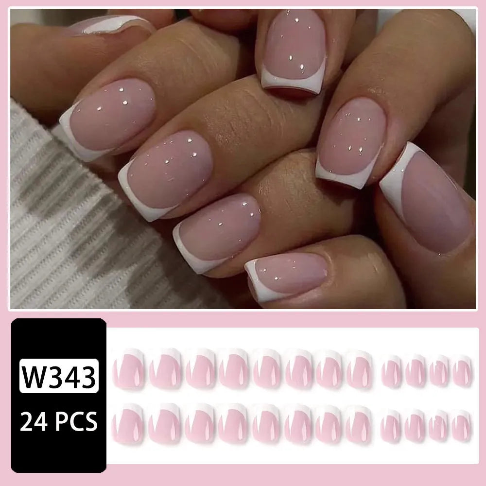 24 white plastic fake nails with a black and grey plaid pattern, arranged on a table.
