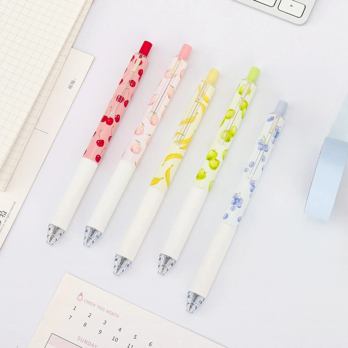 Three fruit scented 0.5mm black ink click pens with plastic barrels and replaceable refills