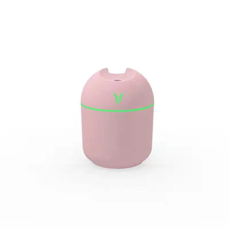 Round desktop humidifier in ivory white with USB cable and single mist outlet