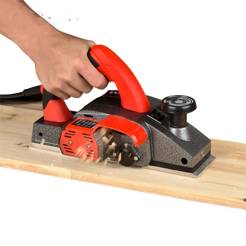Red electric wood planer tool with aluminium body for carpentry work