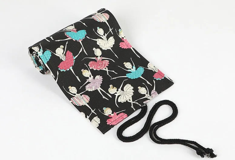 Canvas rolling pencil case with ballet girl print, showing multiple holes for colour pencils.