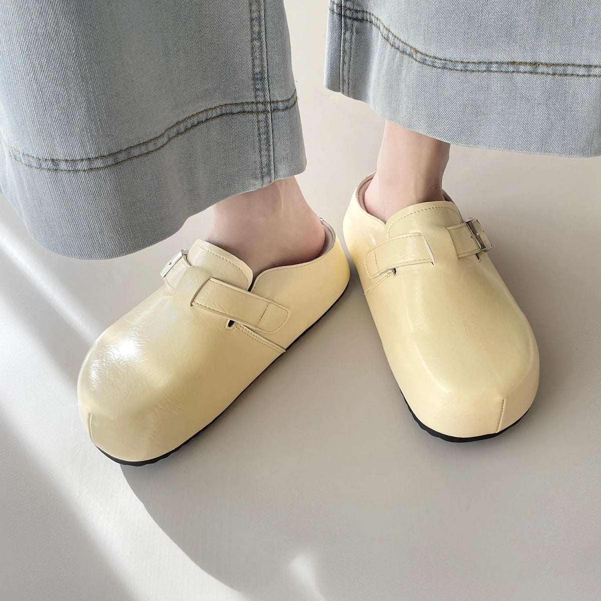 Flat buckle casual sneakers with round toe design in yellow, creamy-white, silver, and black colour options