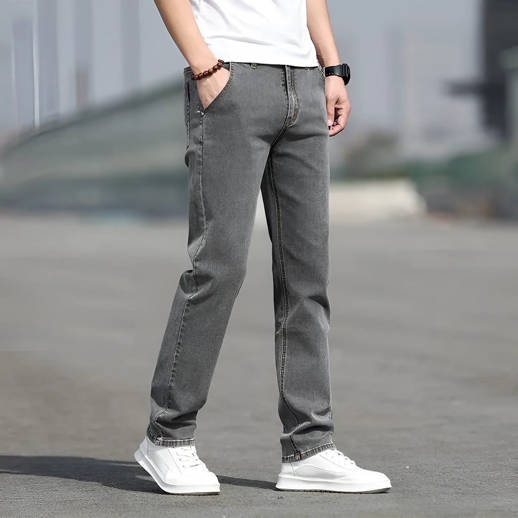 Men's smoky gray straight leg jeans with low waist design and zipper fly closure