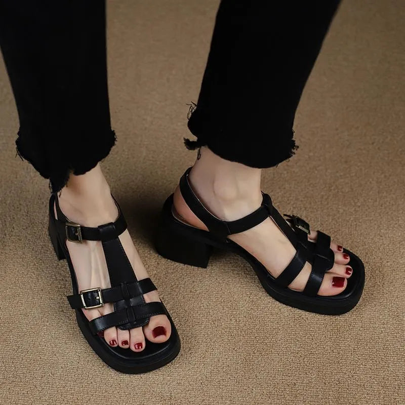 Black retro women's sandals with T-buckle, chunky platform heel and open square toe.