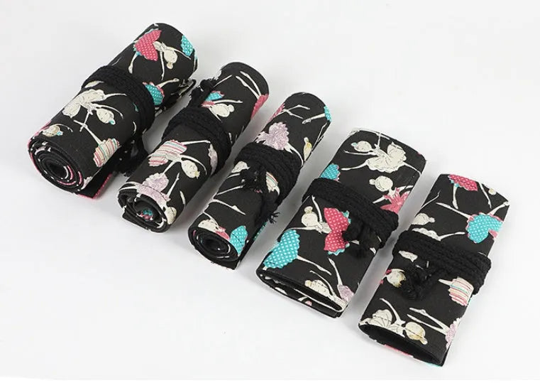 Canvas rolling pencil case with ballet girl print, showing multiple holes for colour pencils.