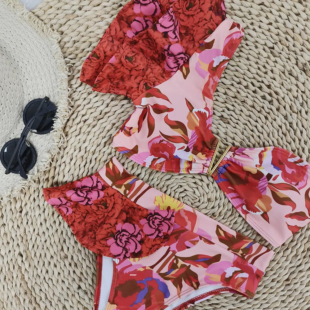 Women's pink floral print one-shoulder swimsuit with high-waist briefs and ruffled detailing