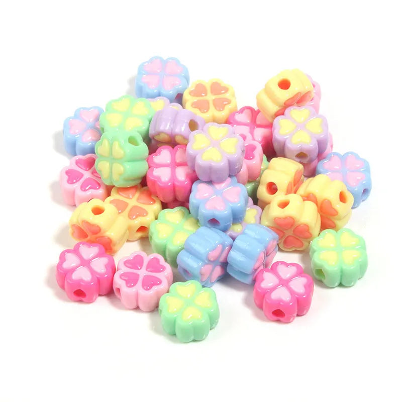 15mm acrylic clover-shaped beads with love pattern in multiple pastel colours including rose red, pink, yellow, green, blue, and purple