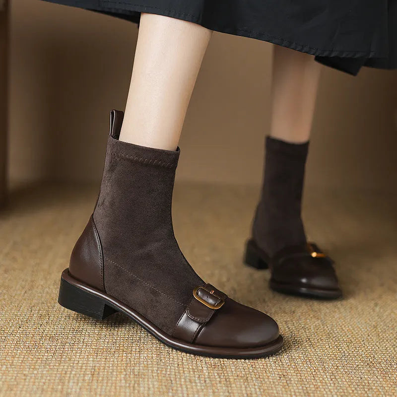 Black women's low heel Martin boots with belt buckle stitching and round toe.