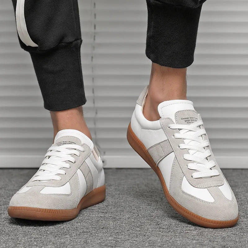 White Japanese-style retro low-top sneakers with round toe and lace-up front on a rubber sole.