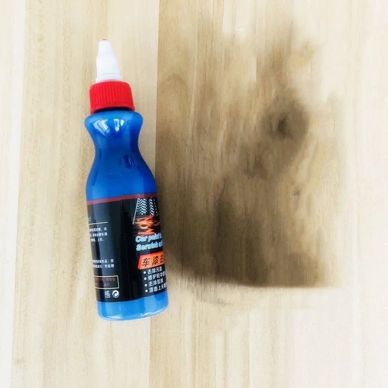 Small blue wiping tool and bottle of automobile scratch repair agent for minor vehicle surface imperfections