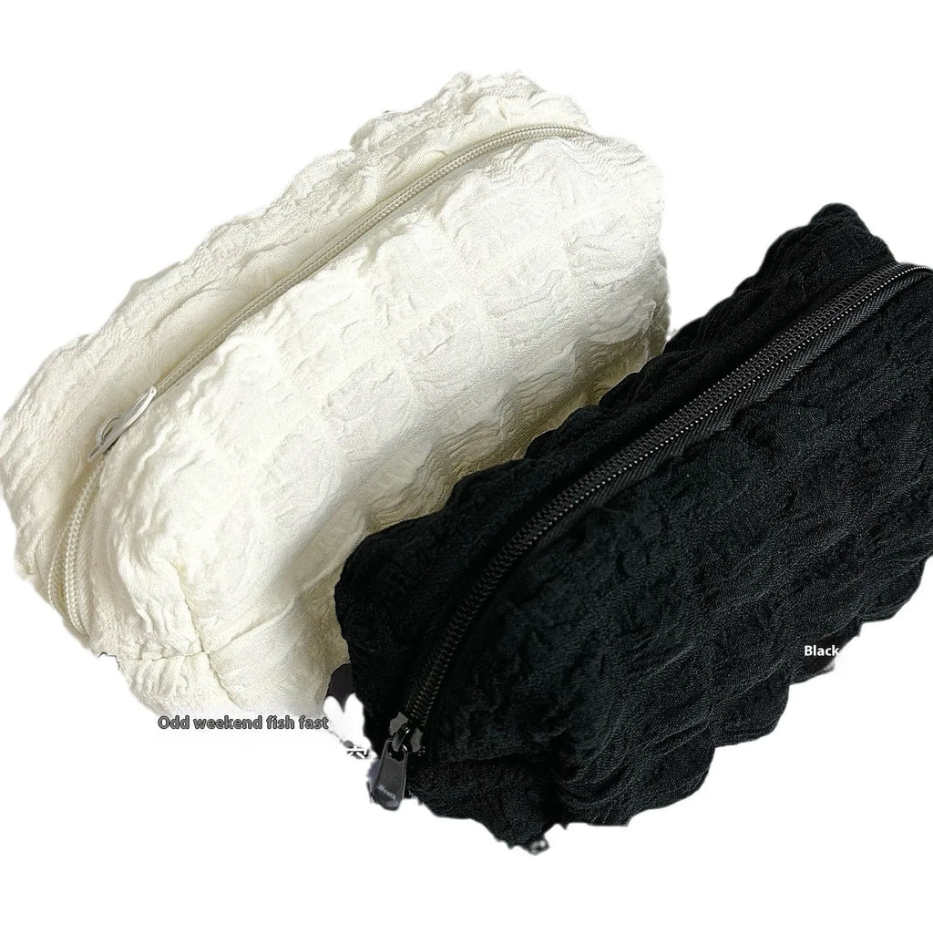 Fabric cream puff style pencil case in polyester material showing beige and black colour options
