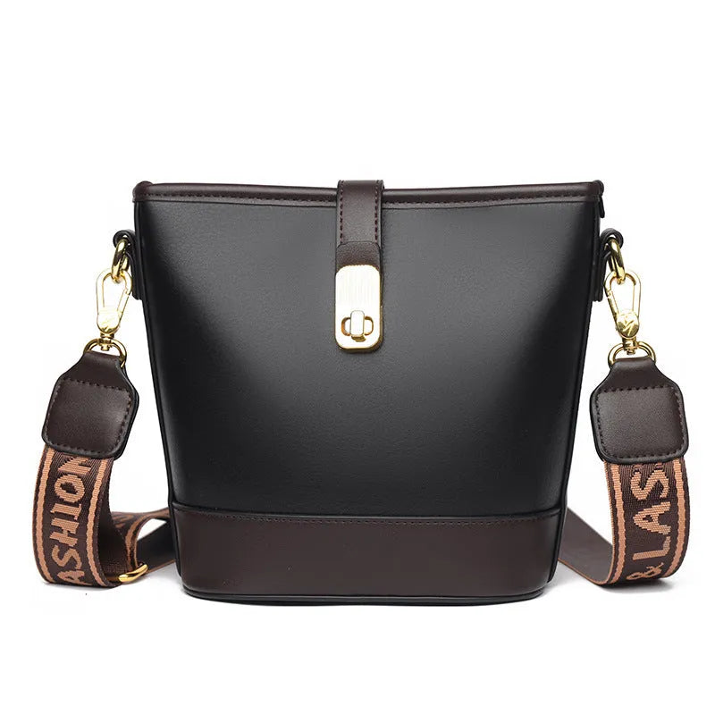 Korean style black bucket messenger bag with double shoulder strap showing zip compartments and urban design details
