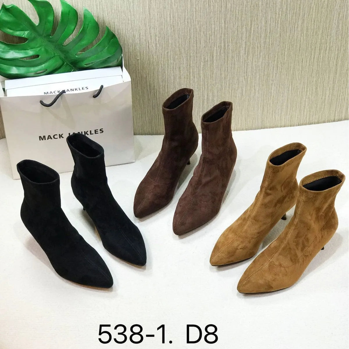 Women's black pointed toe ankle boots with a stiletto heel on a white background.