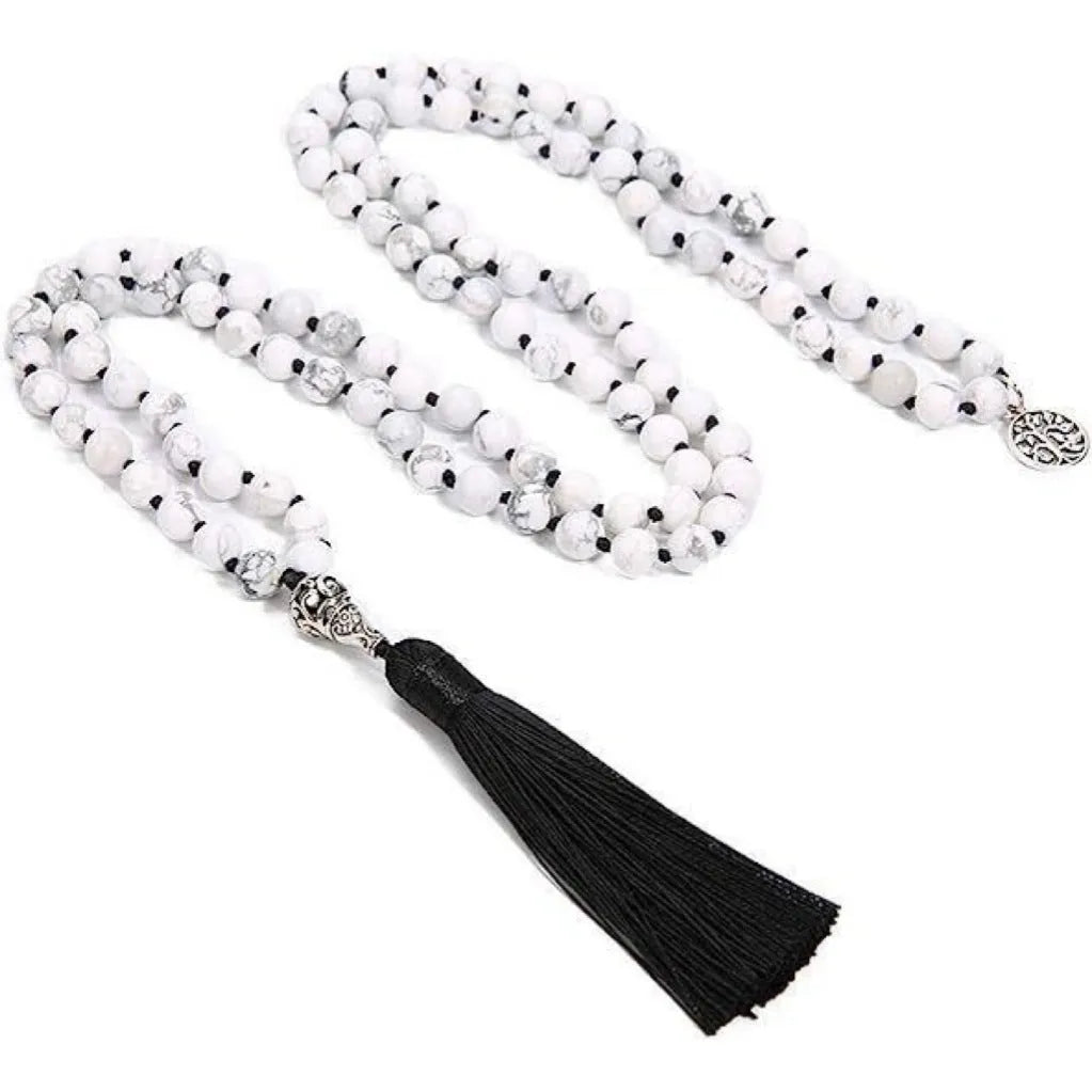 Handmade knotted beaded necklace with geometric stone pendant in natural colours.
