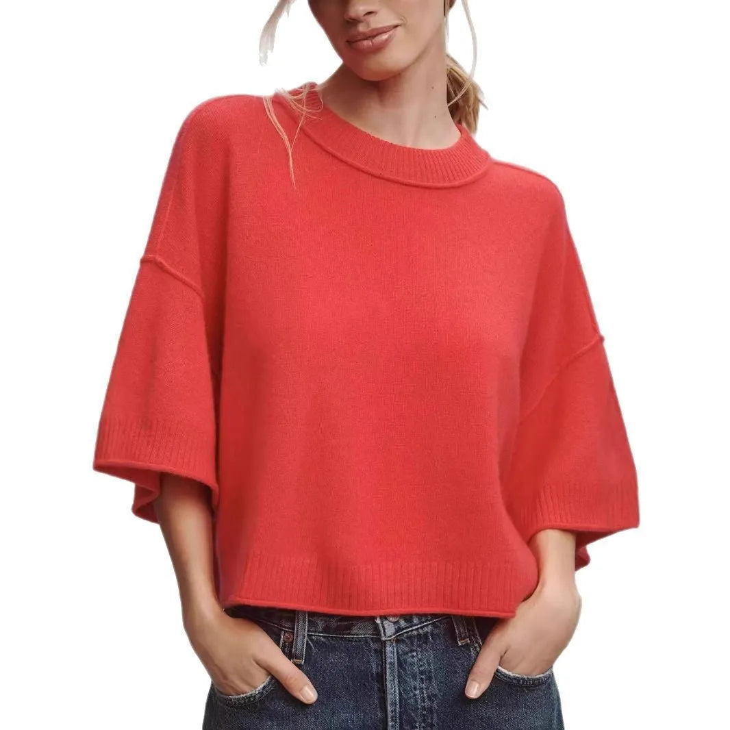 Red cropped viscose t-shirt on a hanger, showing its short length and regular sleeves.