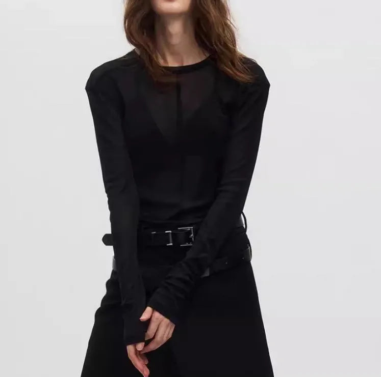 Black slim-fit mesh see-through long sleeve pullover on a model, showing texture.