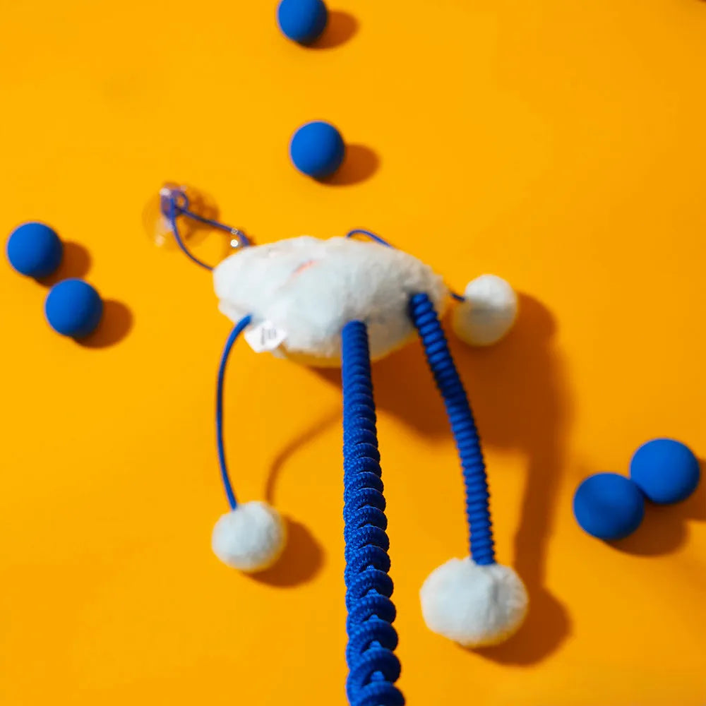 Mint coloured plush ring cat toy on a telescopic elastic rope with a bell inside the ring.