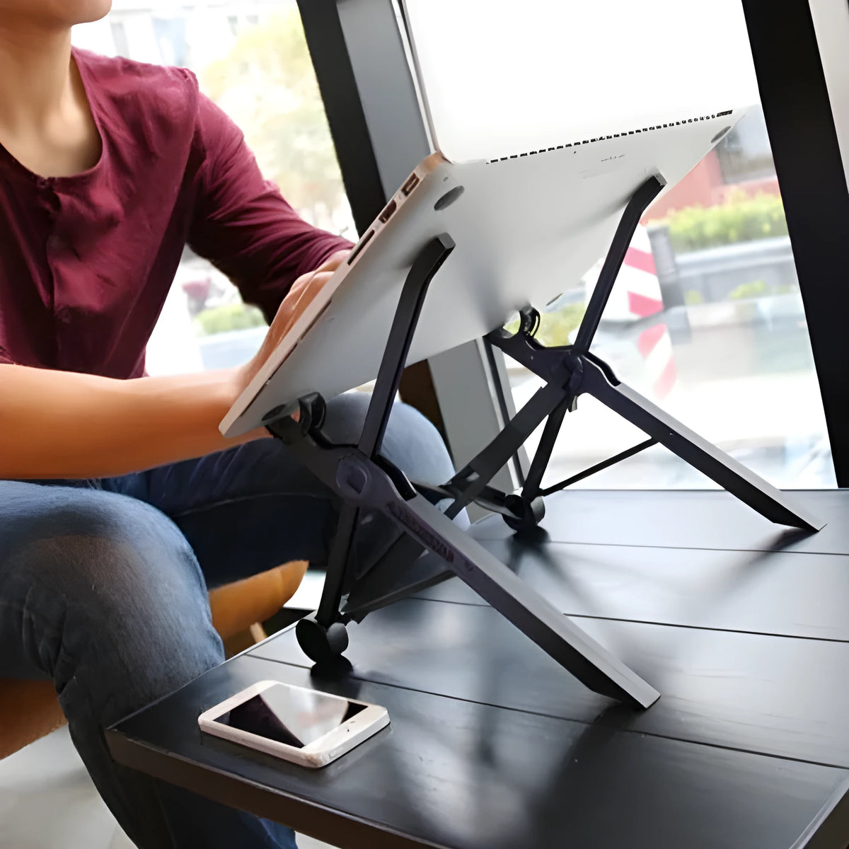 Sagacious black portable folding computer bracket showing adjustable height mechanism