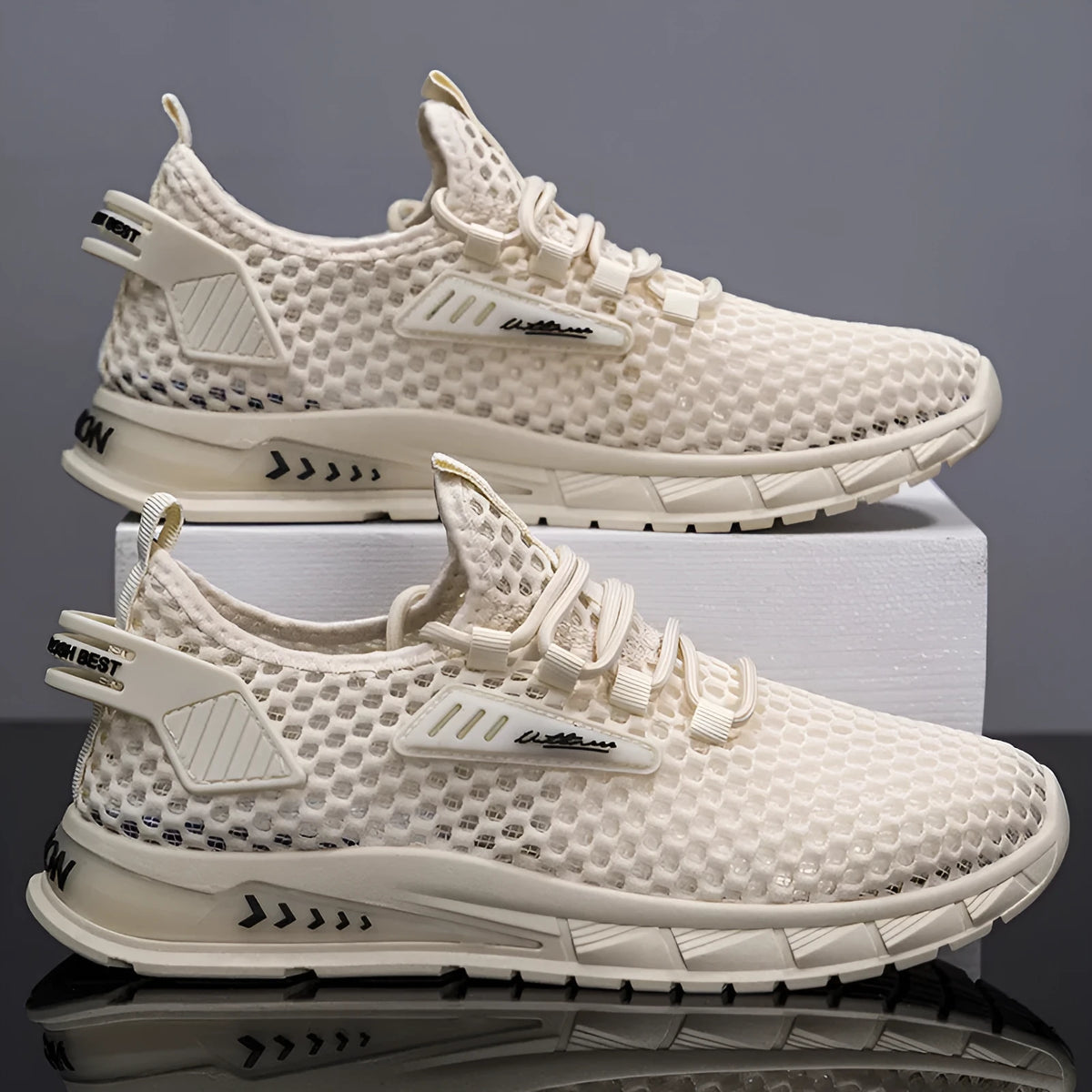 Men's beige lace-up sneaker with mesh detailing and a synthetic leather upper on a white background.