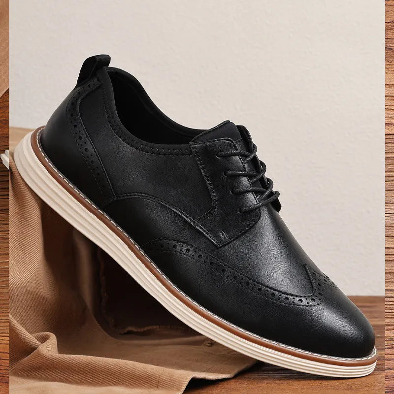 Men's black slip-on business casual shoes with round toe and carved detail on a PU upper.