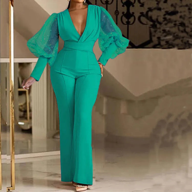 Women's long sleeve jumpsuit with mesh stitching detail, elastic waist, and wide leg in red colour