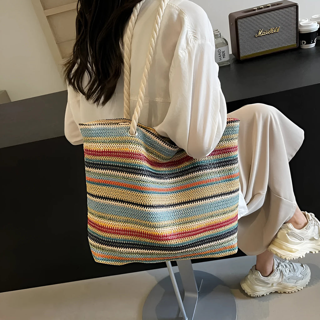 Blue straw woven large capacity single shoulder bag with nylon exterior and polyester lining.