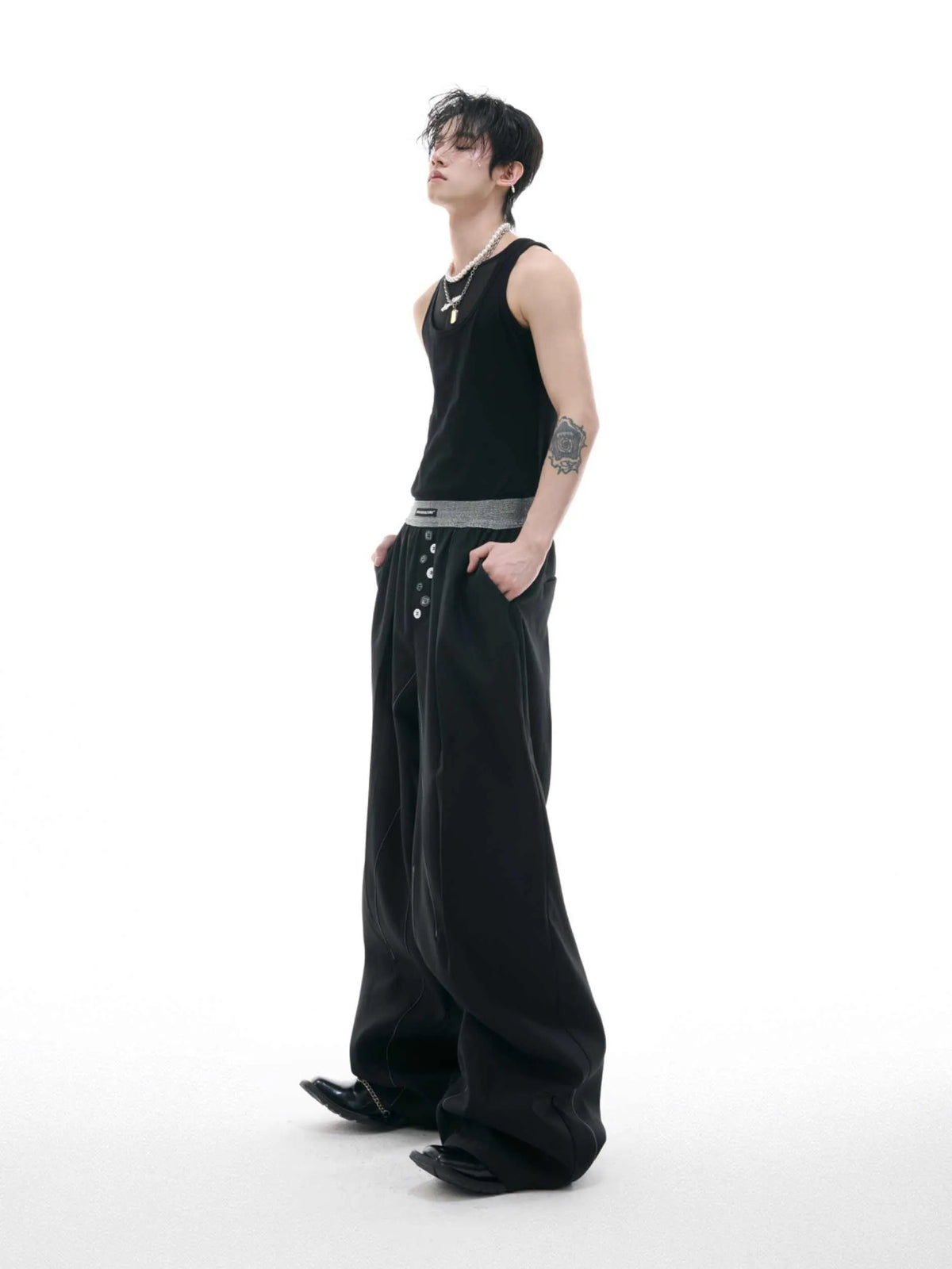 Black straight leg trousers with high waist design and button detail on front