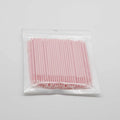 Disposable micro applicator brushes with bendable cotton swab heads and coloured handles for makeup and eyelash extensions